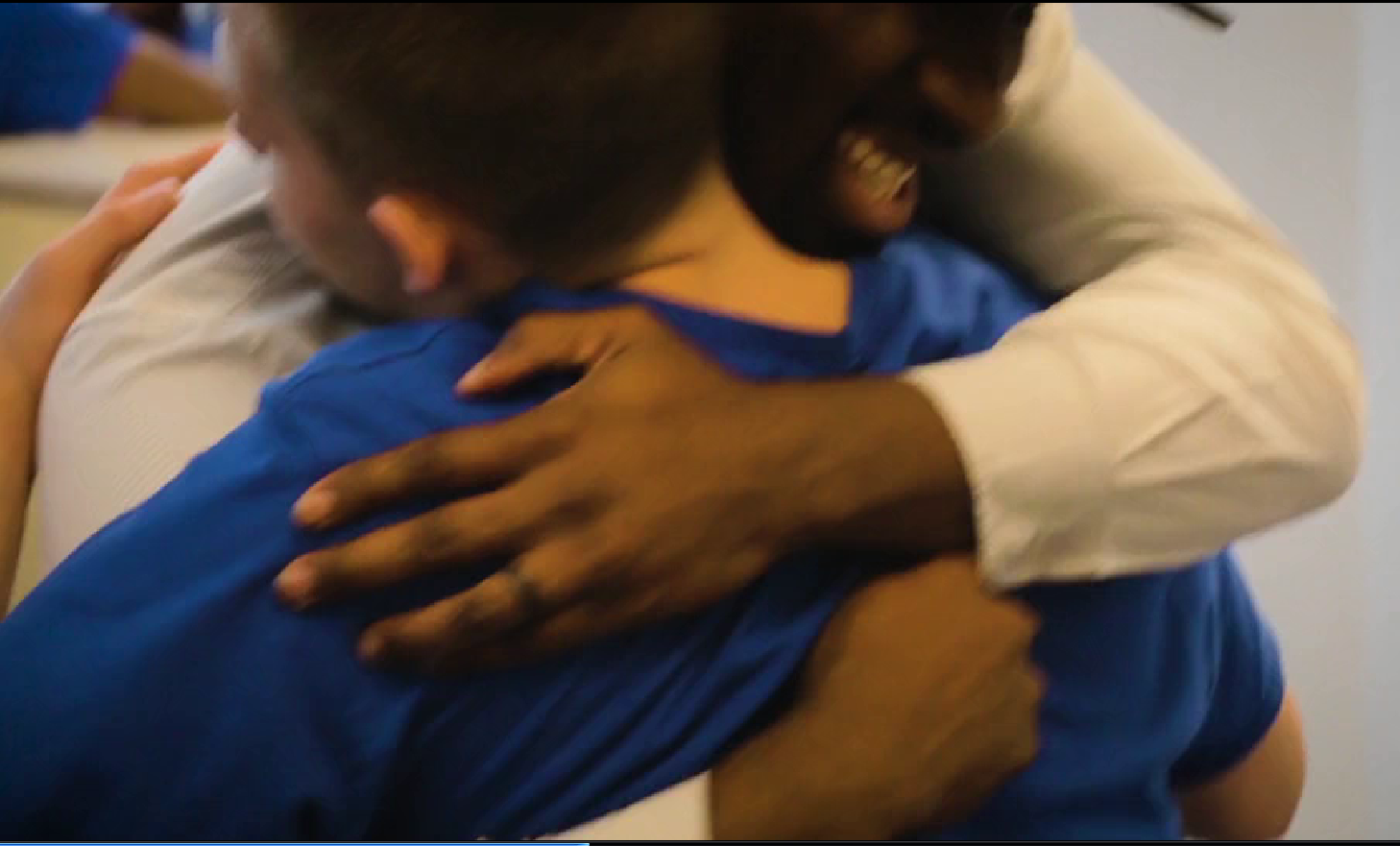 leader hugging student