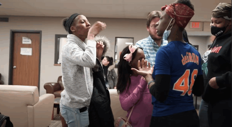 a group of teenage girls signing to each other