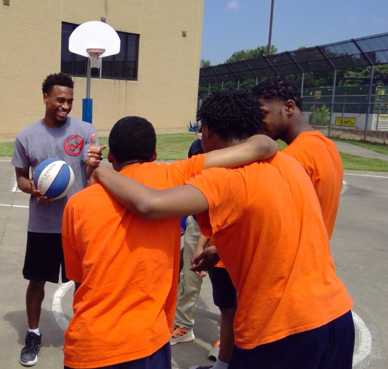 incarcerated youth playing basketball and hearing the Gospel